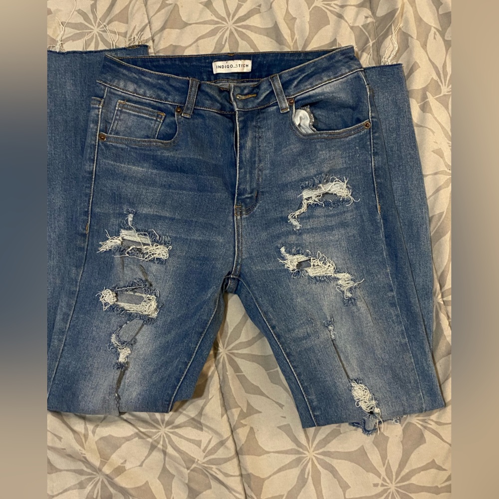 Straight leg light denim jeans. Lightly distressed.